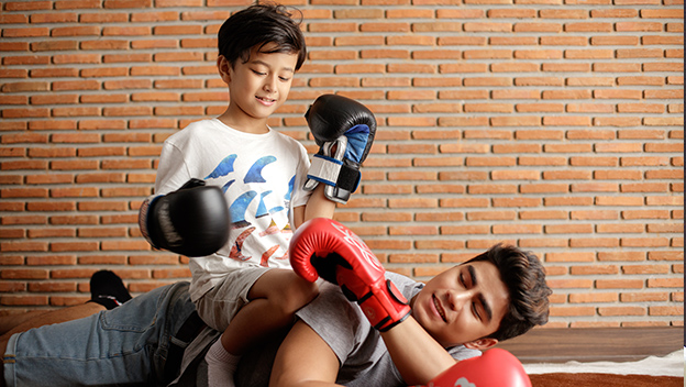 Father and son playing rough